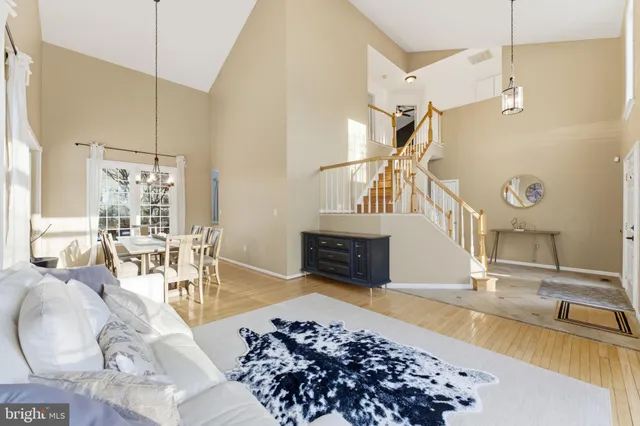 a view of a dining room with furniture large windows and wooden floor