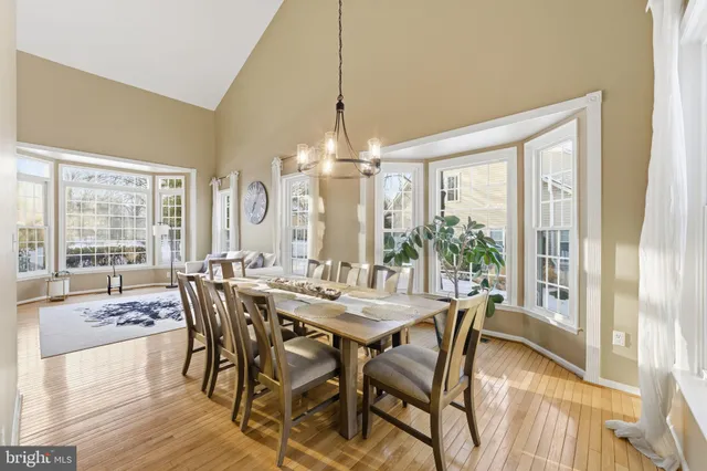 a view of a bedroom with wooden floor and furniture