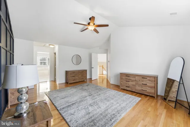 a bedroom with bed and ceiling fan