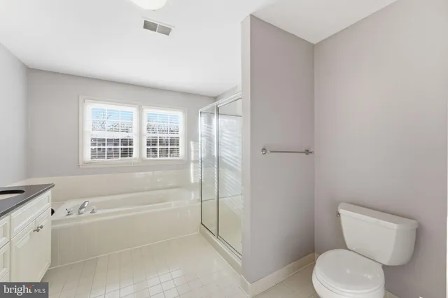 a bathroom with a sink toilet a mirror and shower