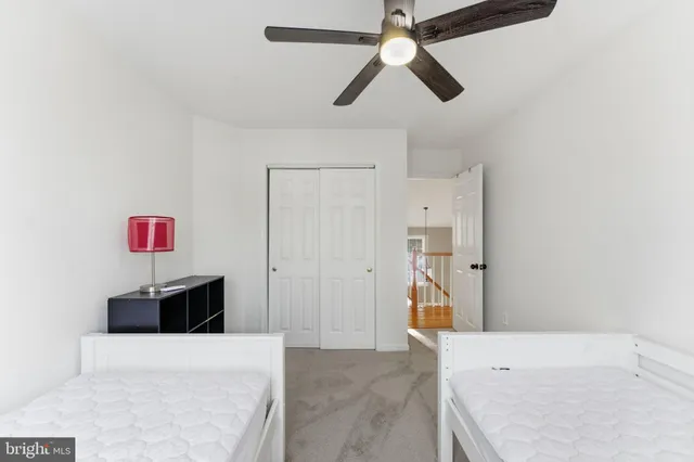 a bedroom with a bed and a night stand