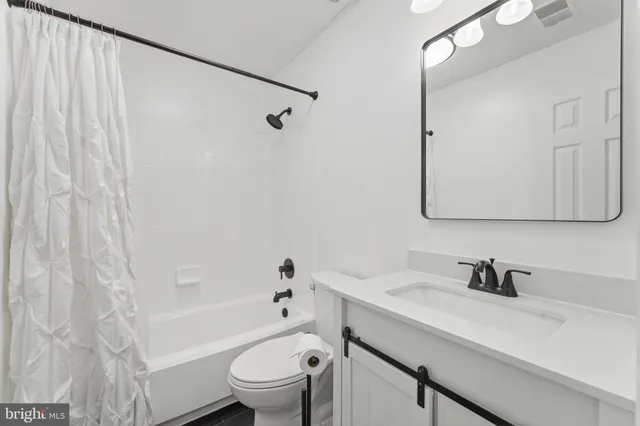 a bathroom with a toilet a sink and shower