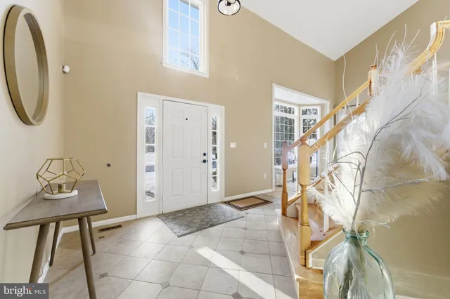 a living room with furniture a table and a large window