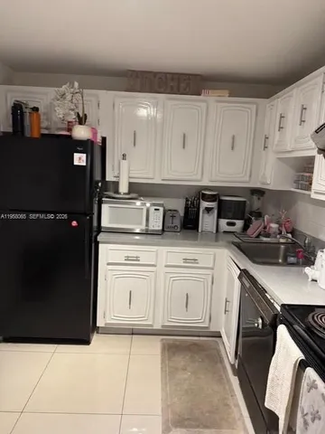 a kitchen with stainless steel appliances granite countertop a refrigerator and a stove