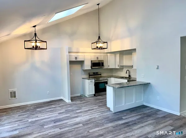 a kitchen with a sink cabinets and window