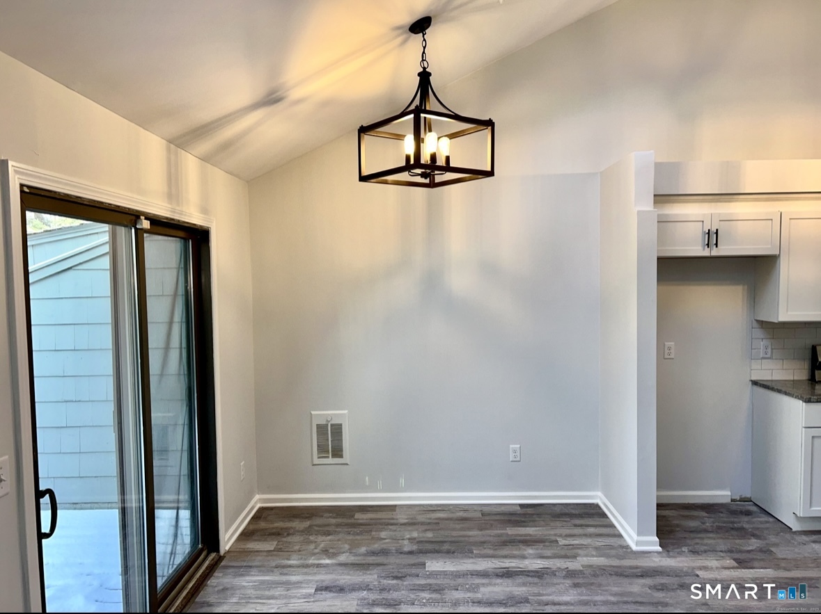 274 Cliffside Drive, Unit 274 Torrington, CT 06790 - Photo 5 of 9 a view of a room with wooden floor and staircase