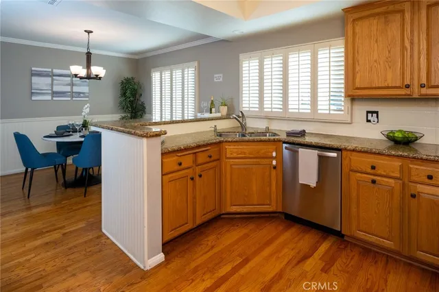 a kitchen with sink cabinets and wooden floor