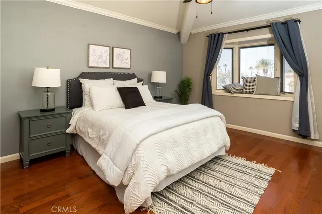 a bedroom with bed and wooden floor