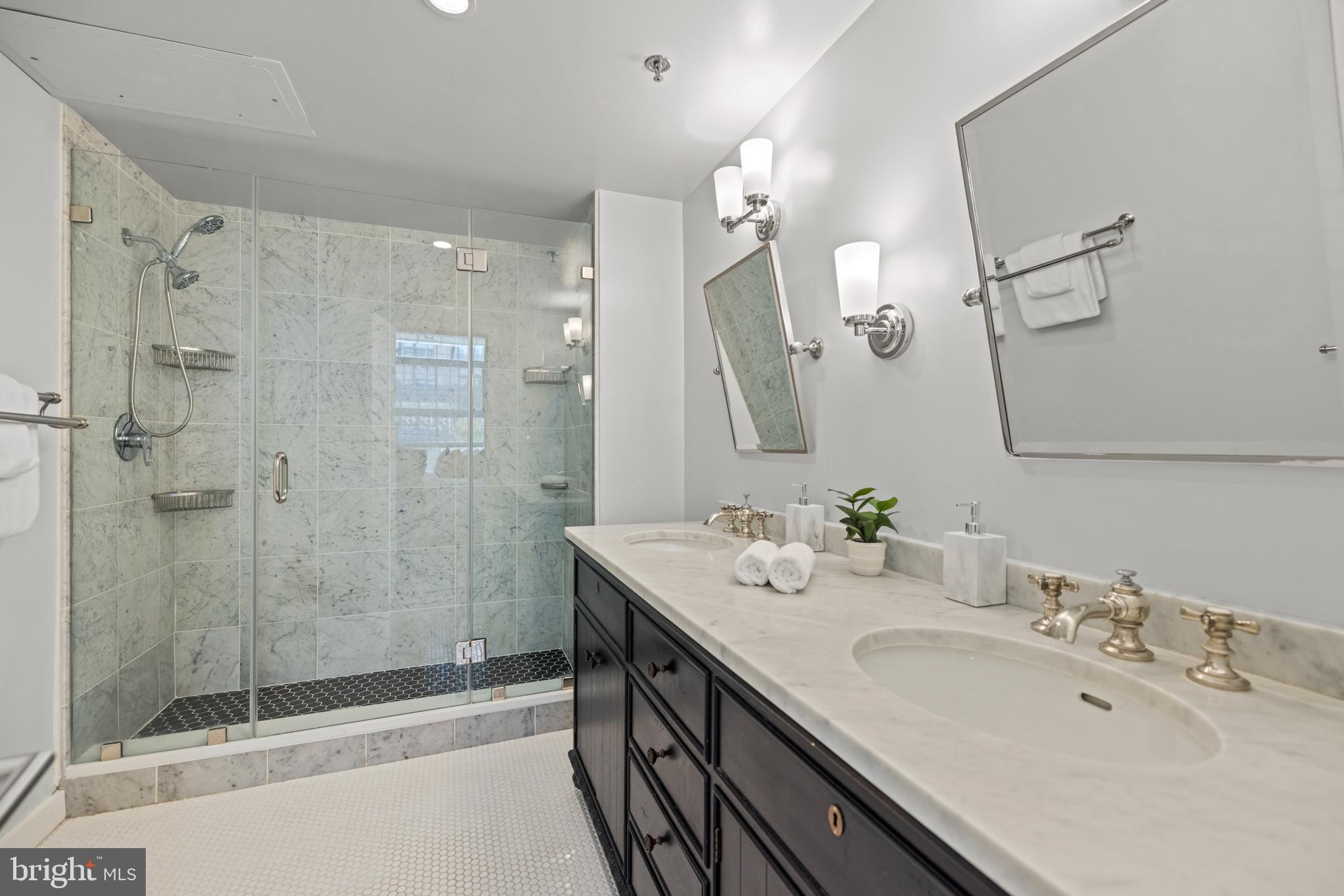1401 Church Street Northwest, Unit 321 Washington, DC 20005 - Photo 15 of 33 a bathroom with a double vanity sink mirror and shower