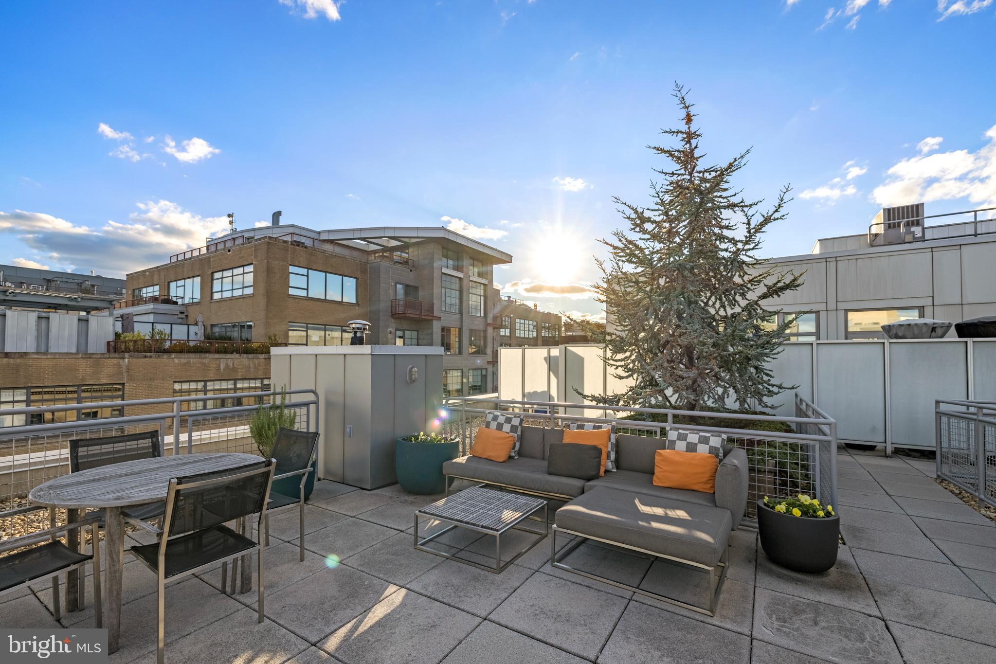 1401 Church Street Northwest, Unit 321 Washington, DC 20005 - Photo 29 of 33 a view of a patio with couches table and chairs and potted plants