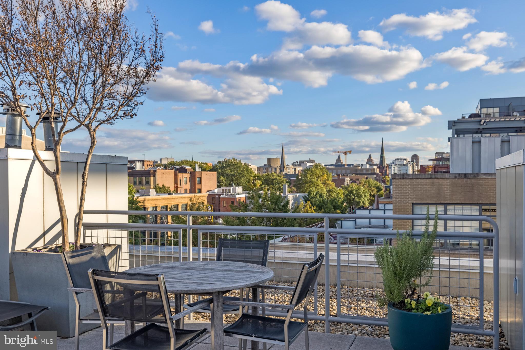 1401 Church Street Northwest, Unit 321 Washington, DC 20005 - Photo 30 of 33 a view of a chairs and table on the terrace