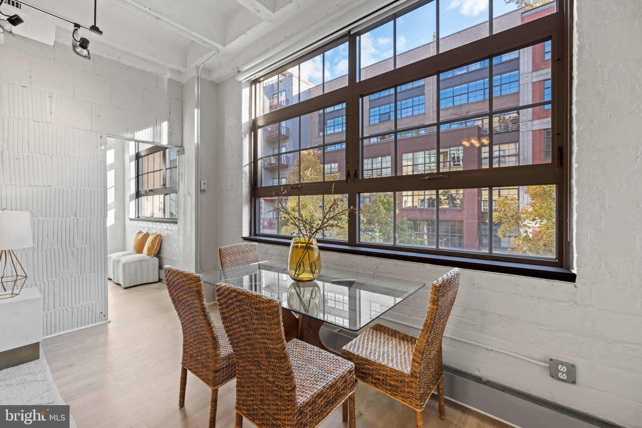 1401 Church Street Northwest, Unit 321 Washington, DC 20005 - Photo 10 of 33 a dining room with furniture a flat screen tv and windows
