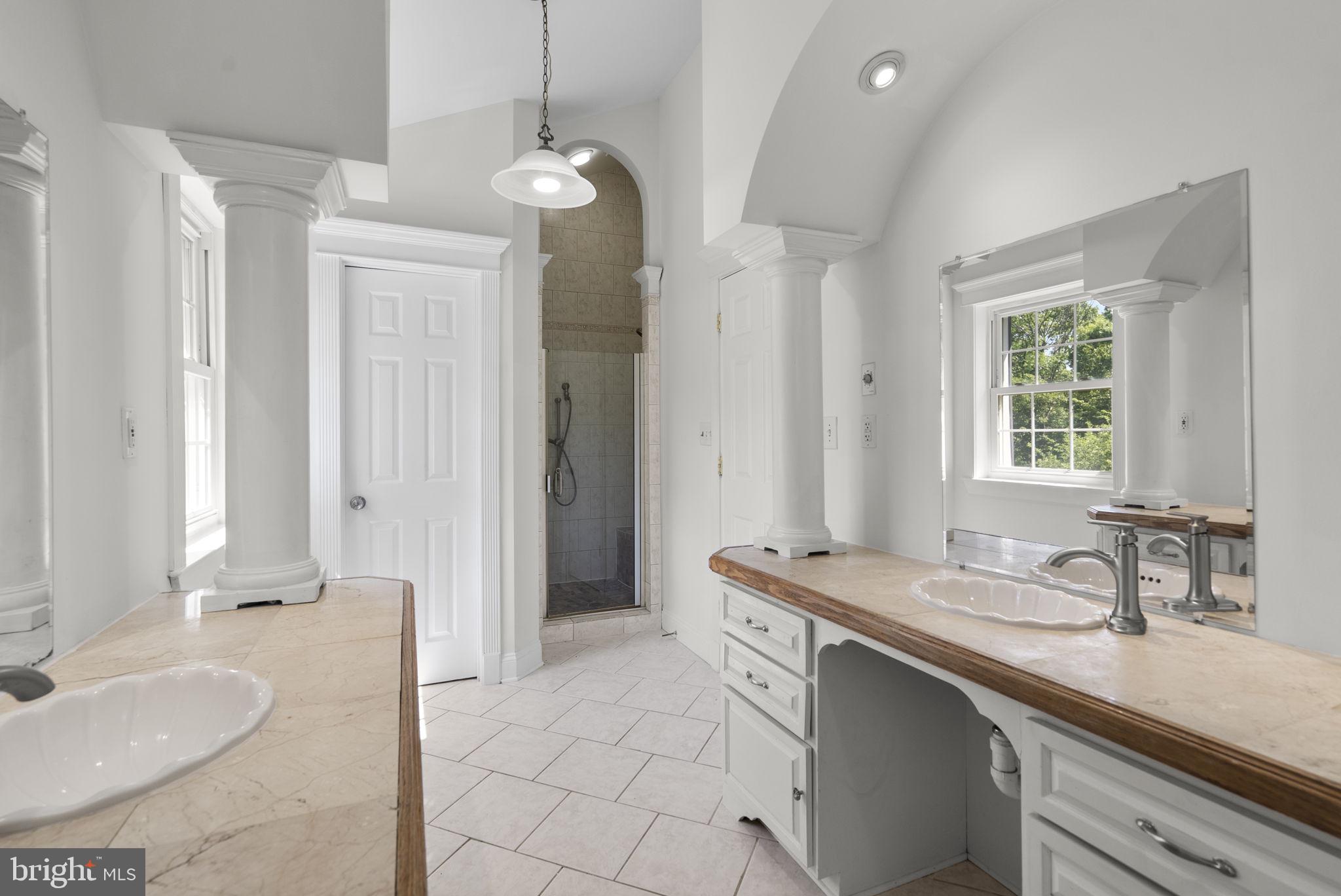 24000 Clarksburg Road Clarksburg, MD 20871 - Photo 29 of 60 a spacious bathroom with a granite countertop sink a toilet a mirror and shower