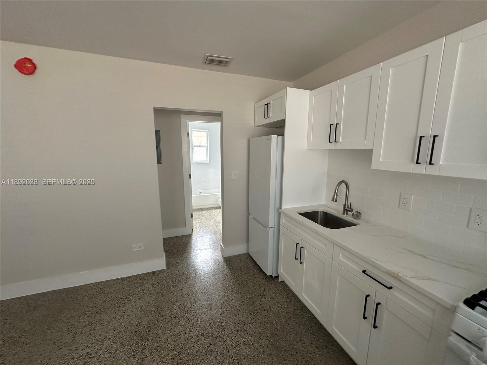211 Southwest 18th Avenue, Unit 2 Miami, FL 33135 - Photo 13 of 14 a kitchen with stainless steel appliances a sink stove and cabinets