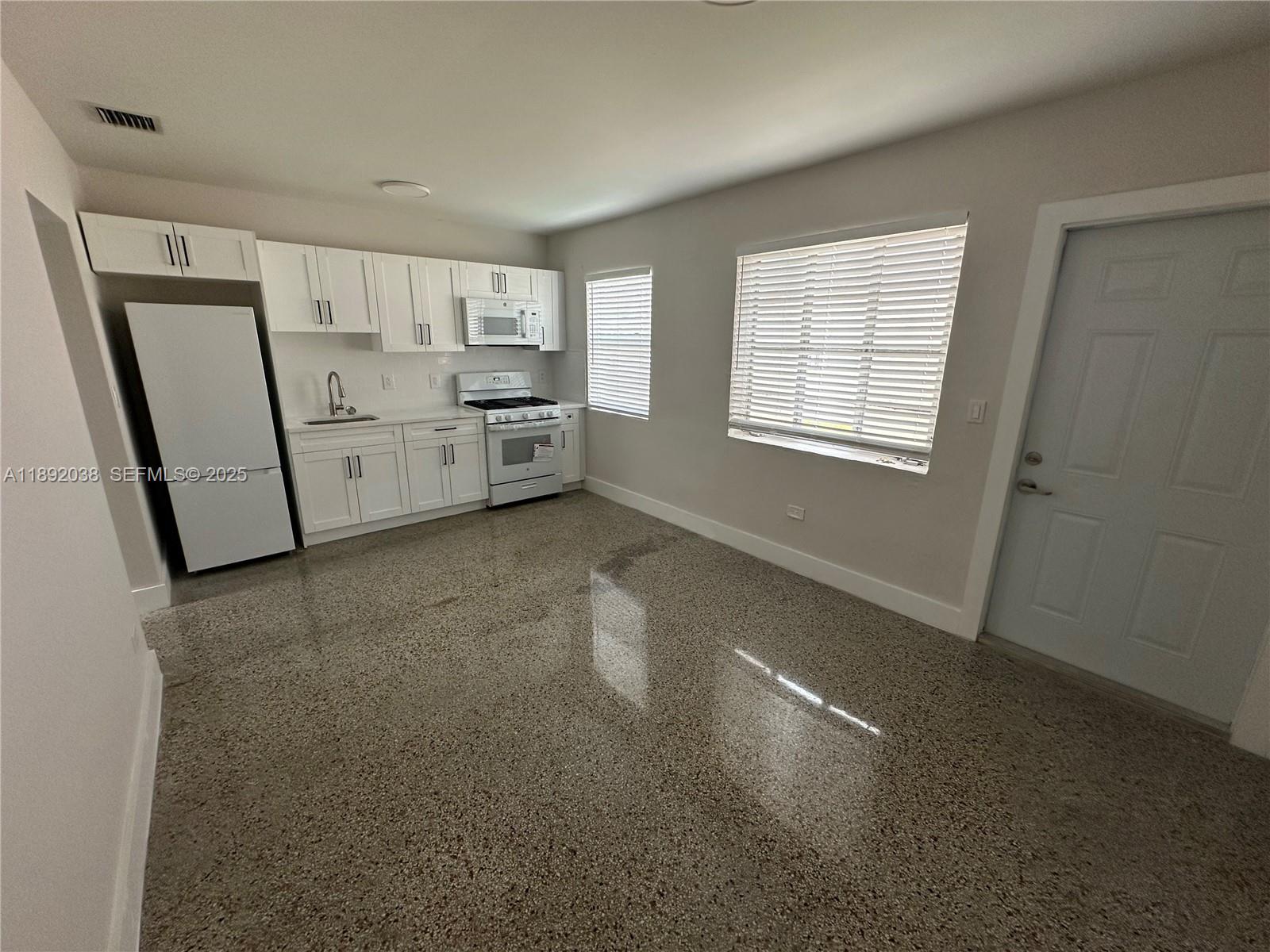 211 Southwest 18th Avenue, Unit 2 Miami, FL 33135 - Photo 14 of 14 a view of a kitchen with refrigerator and windows