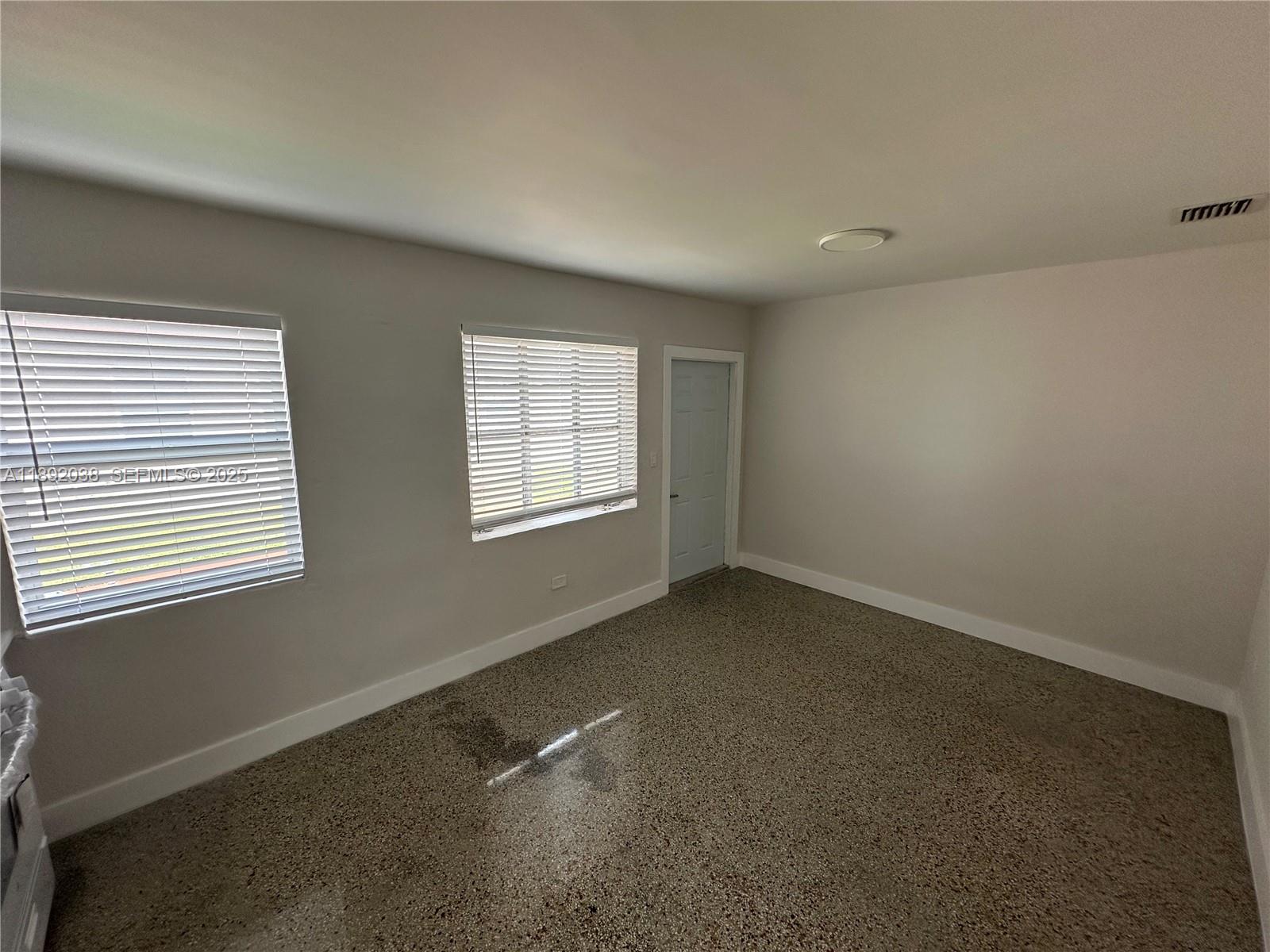 211 Southwest 18th Avenue, Unit 2 Miami, FL 33135 - Photo 3 of 14 an empty room with windows