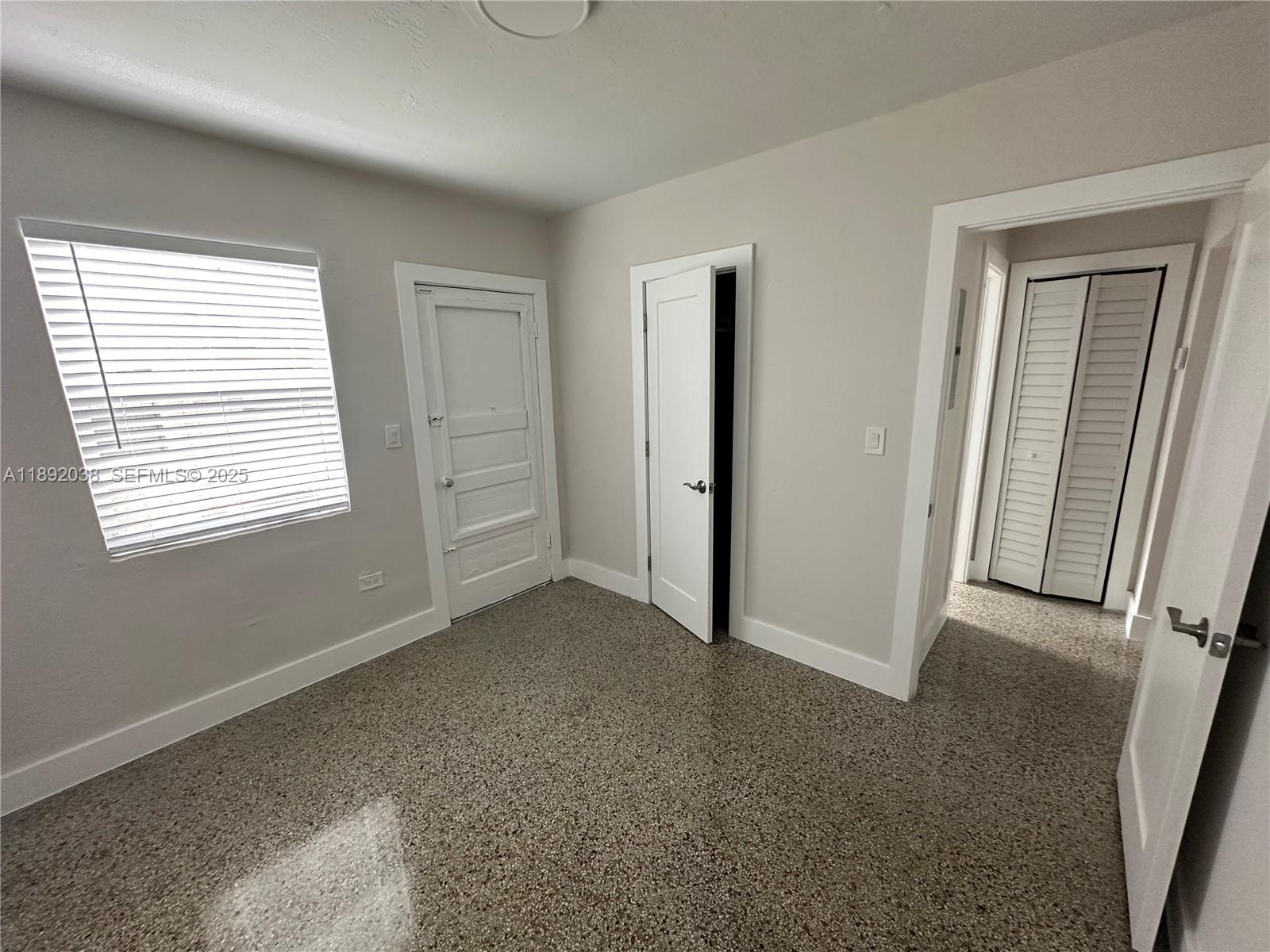 211 Southwest 18th Avenue, Unit 2 Miami, FL 33135 - Photo 7 of 14 an empty room with windows