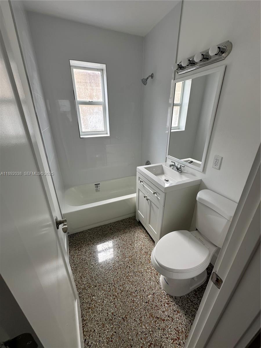 211 Southwest 18th Avenue, Unit 2 Miami, FL 33135 - Photo 9 of 14 a bathroom with a toilet sink and mirror