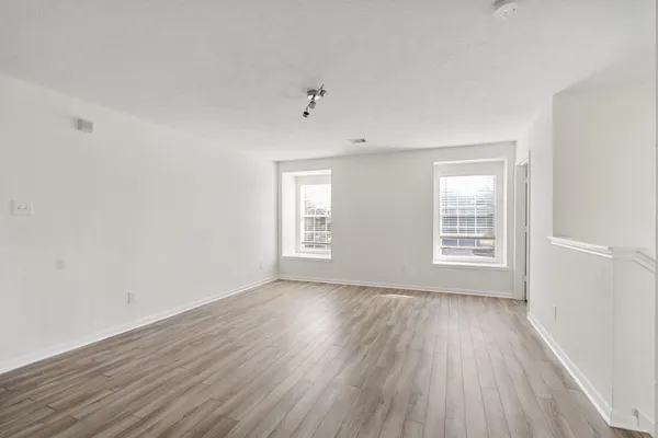wooden floor in an empty room with a window