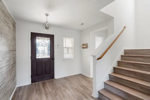a view of an entryway with wooden floor