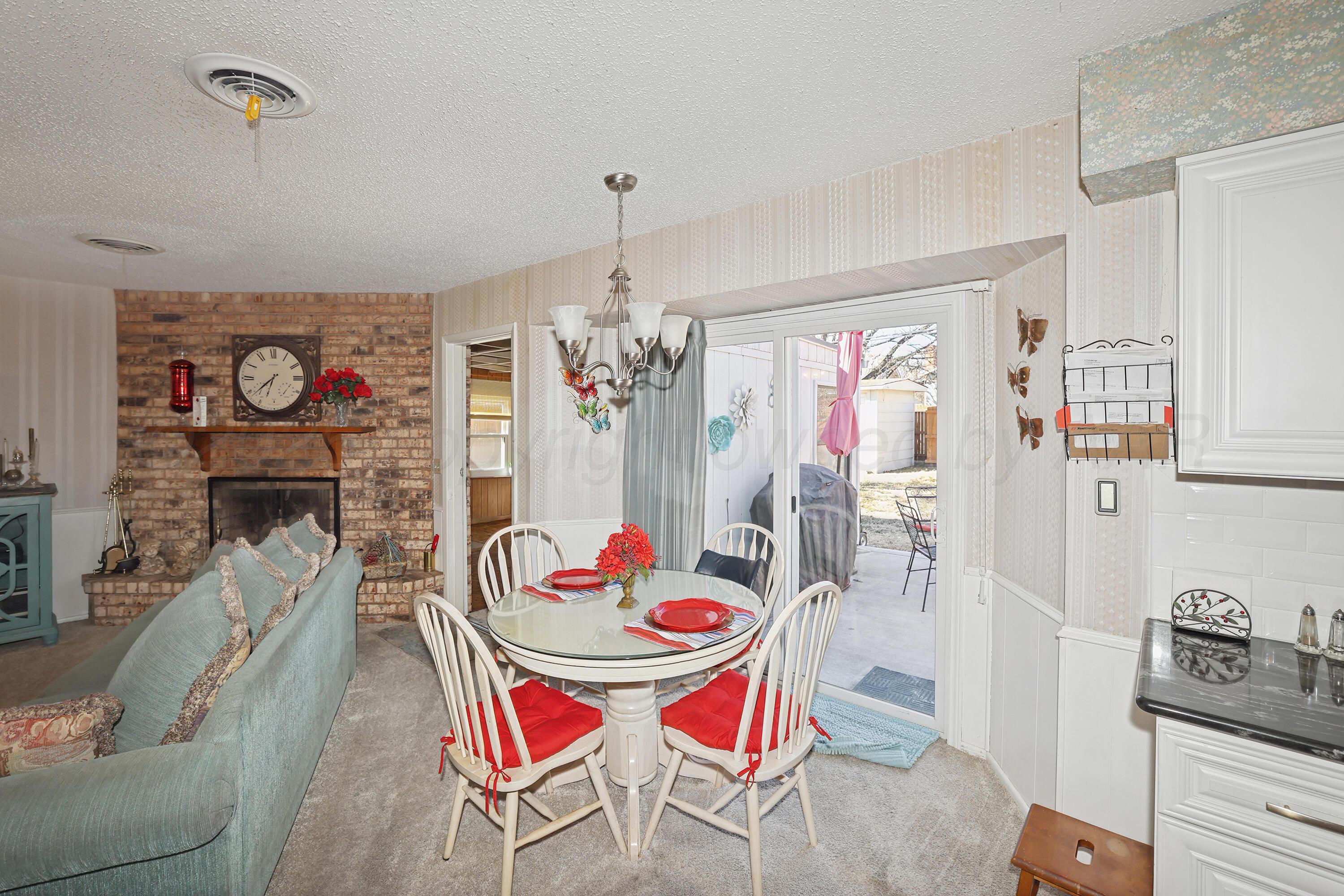 3708 Wayne Street Amarillo, TX 79109 - Photo 11 of 36 a view of a dining room with furniture a chandelier and wooden floor