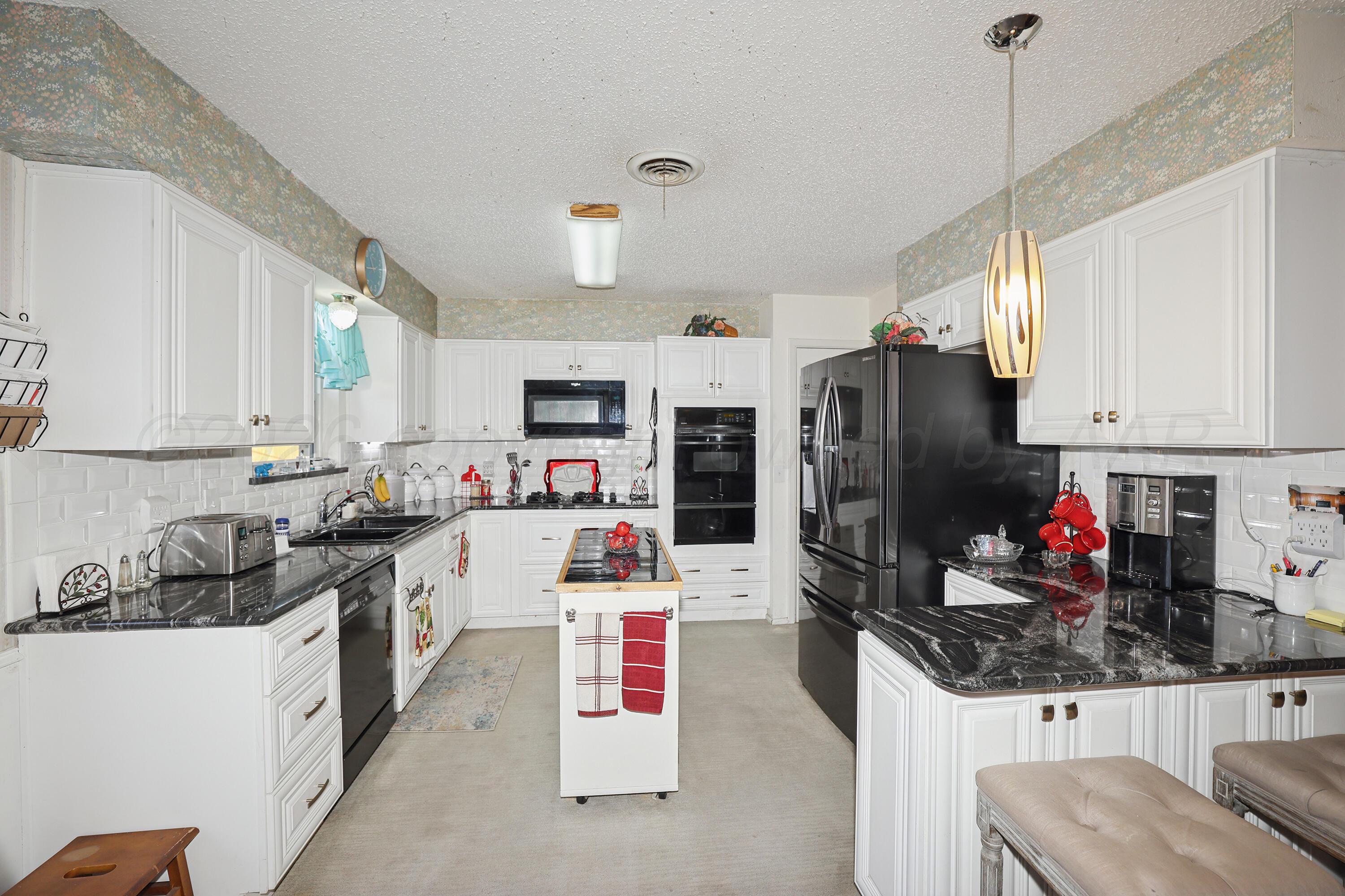 3708 Wayne Street Amarillo, TX 79109 - Photo 12 of 36 a kitchen with refrigerator and cabinets