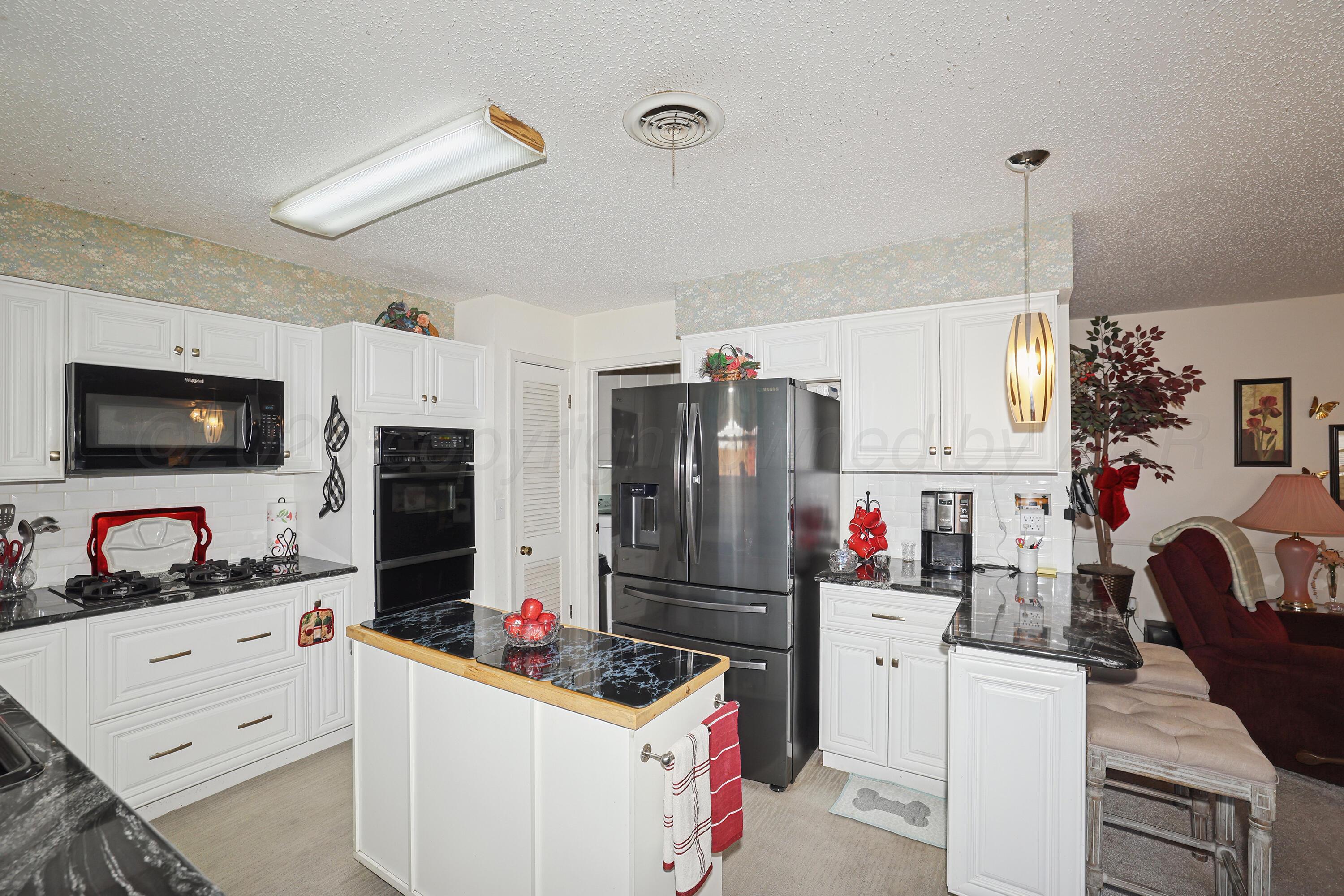 3708 Wayne Street Amarillo, TX 79109 - Photo 14 of 36 a kitchen that has a refrigerator and a stove