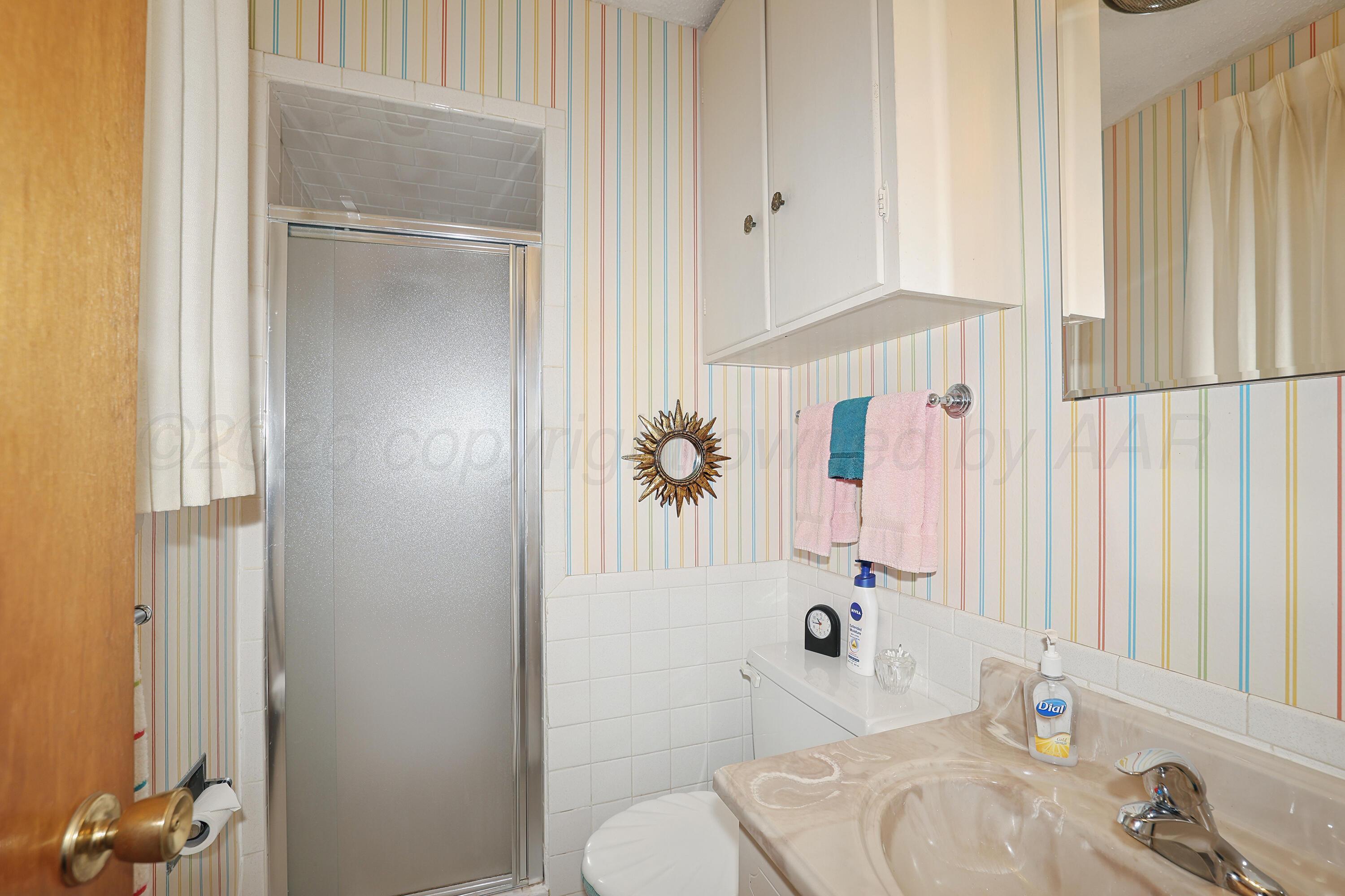 3708 Wayne Street Amarillo, TX 79109 - Photo 19 of 36 a bathroom with a sink and a mirror