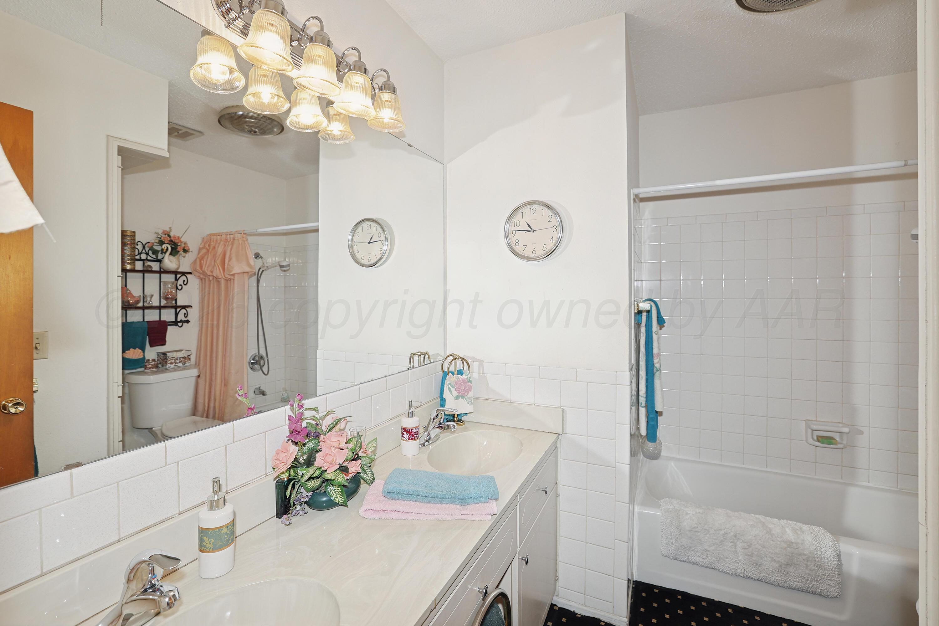 3708 Wayne Street Amarillo, TX 79109 - Photo 25 of 36 a bathroom with a sink vanity granite shower and a mirror