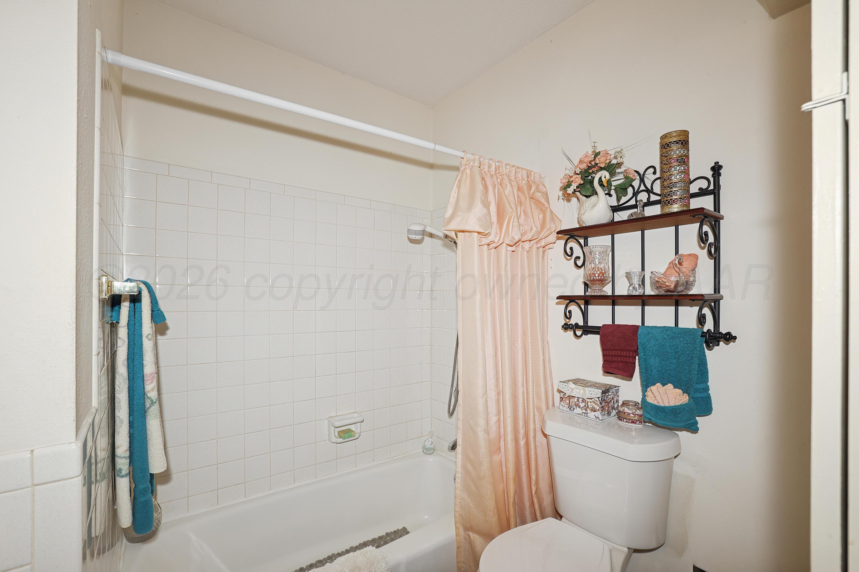 3708 Wayne Street Amarillo, TX 79109 - Photo 26 of 36 a bathroom with a toilet and a shower