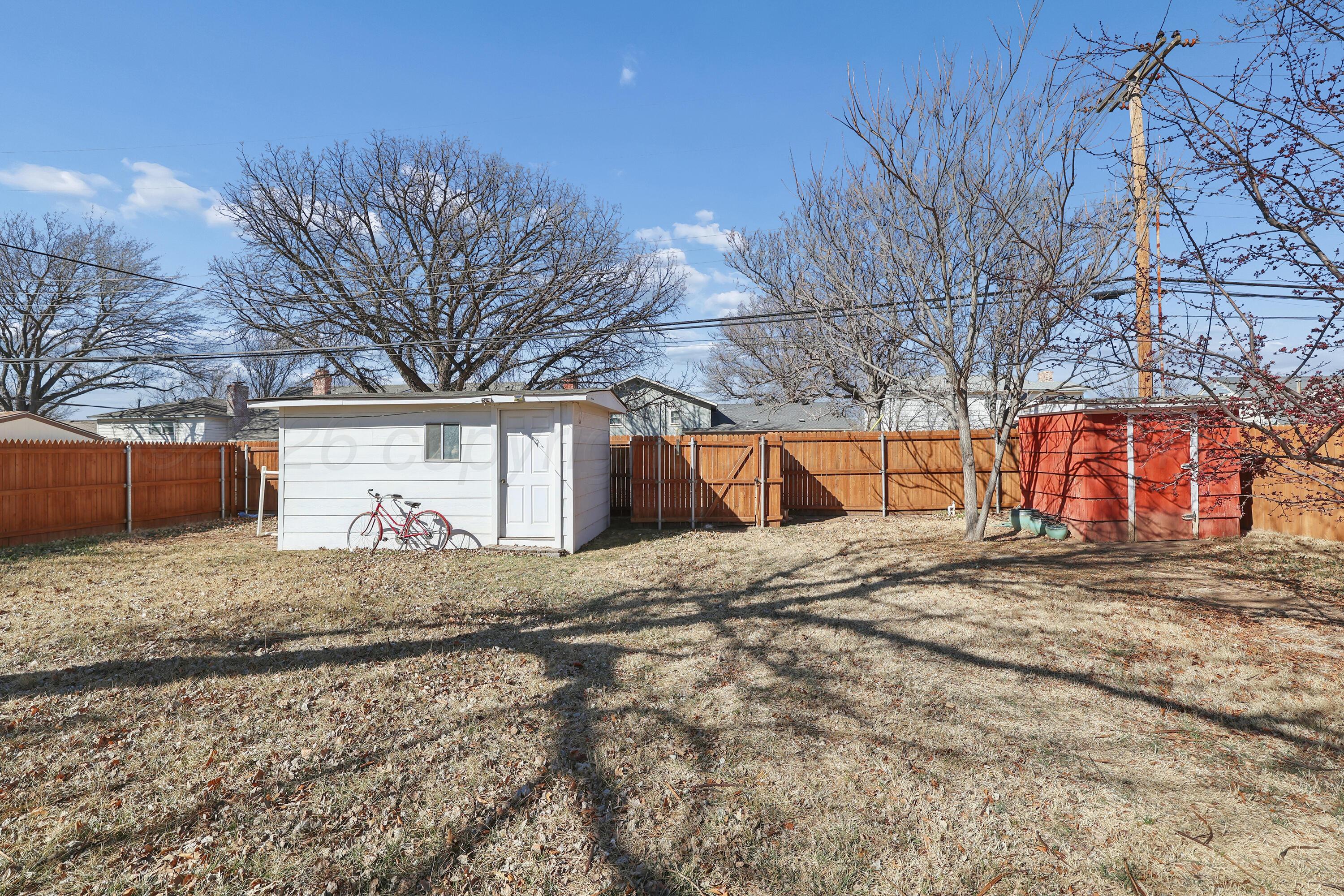 3708 Wayne Street Amarillo, TX 79109 - Photo 32 of 36 a view of a backyard with a large tree