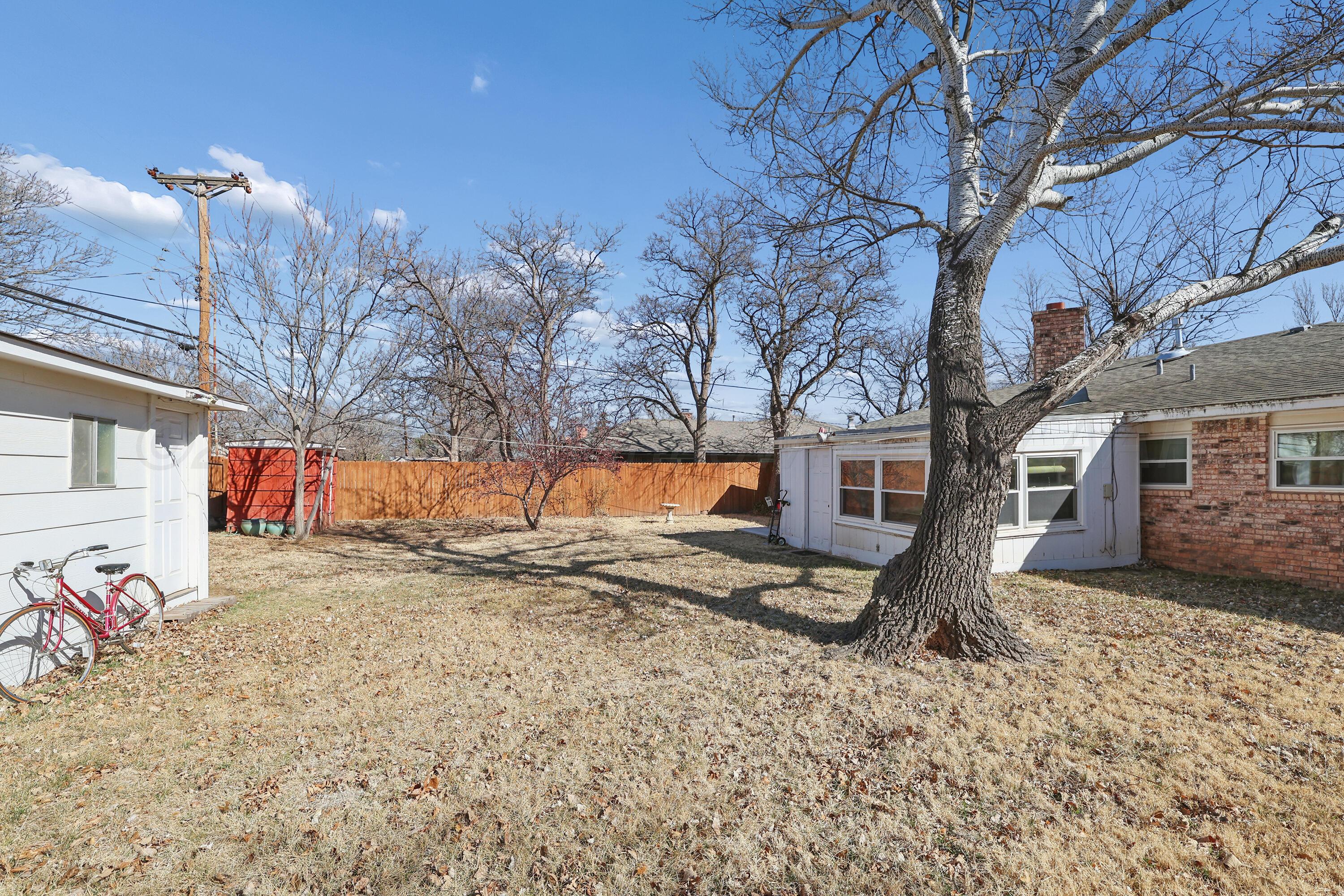3708 Wayne Street Amarillo, TX 79109 - Photo 33 of 36 a backyard of a house with barbeque oven and a tree