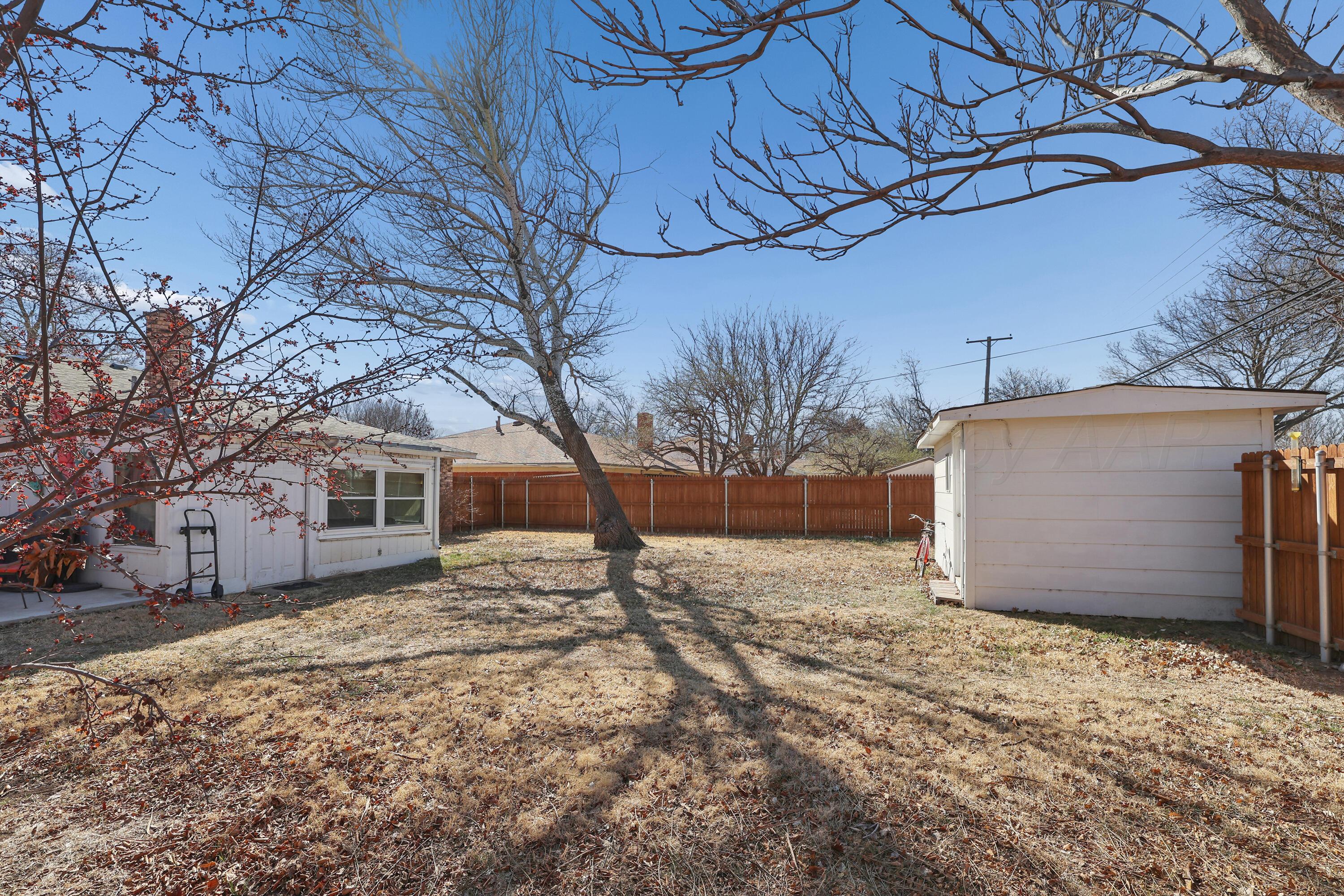 3708 Wayne Street Amarillo, TX 79109 - Photo 34 of 36 a white house that has a tree in front of it