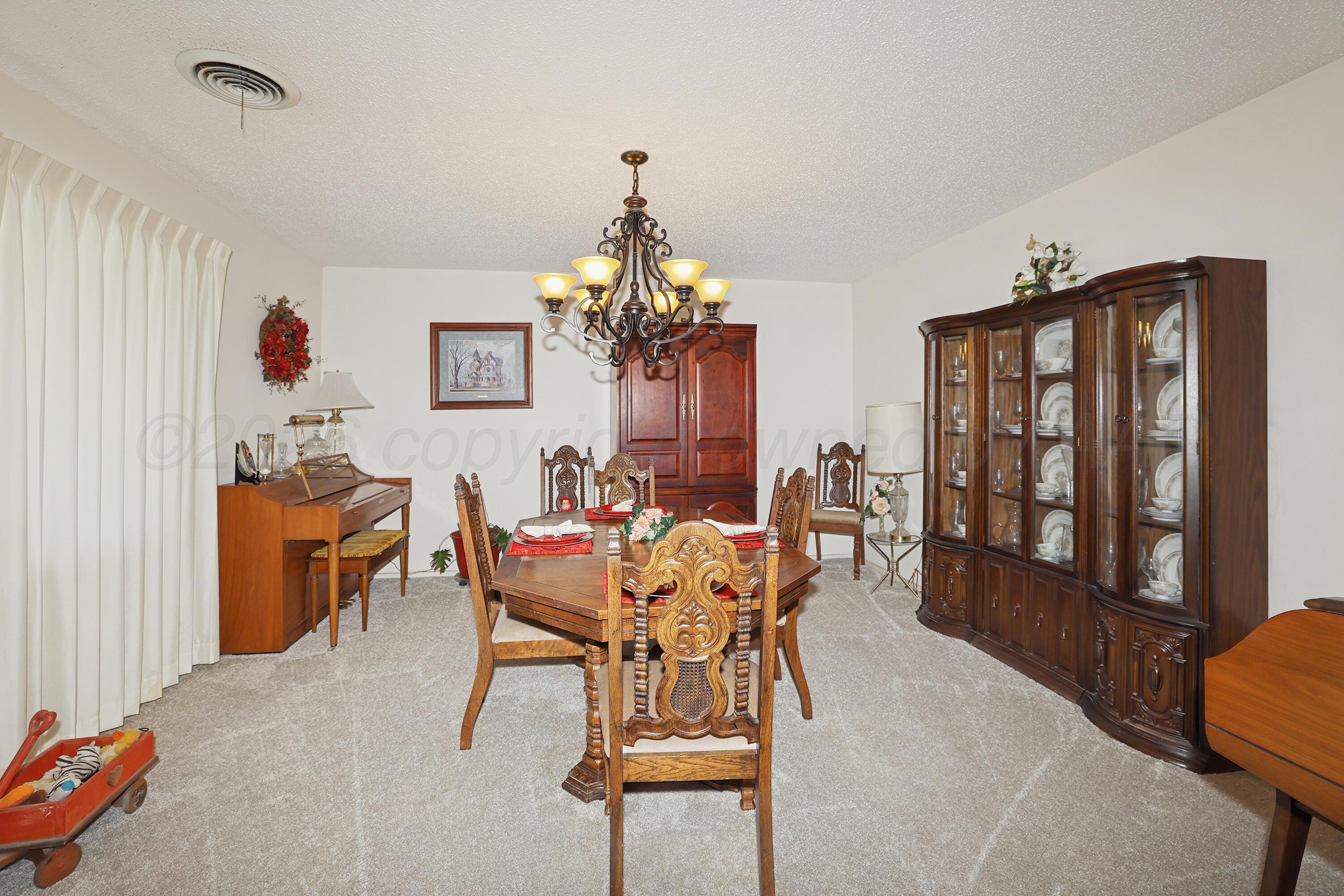3708 Wayne Street Amarillo, TX 79109 - Photo 7 of 36 a dining room with furniture a chandelier and window