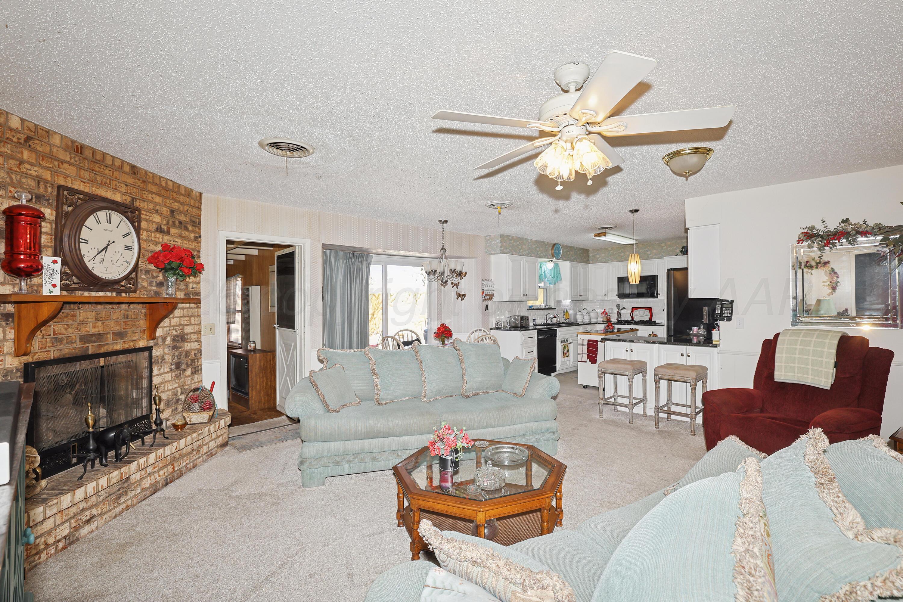 3708 Wayne Street Amarillo, TX 79109 - Photo 10 of 36 a living room with furniture a fireplace and a window