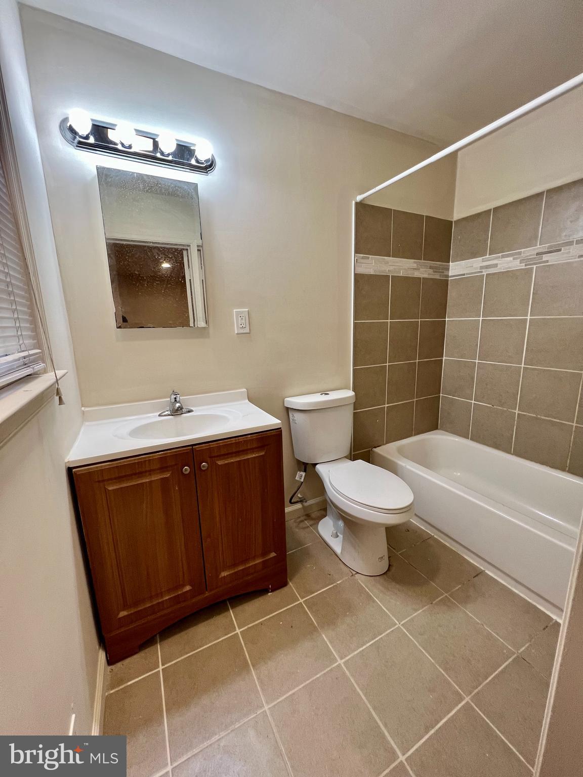 7510 Sanner Road Laurel, MD 20723 - Photo 12 of 26 a bathroom with a toilet a sink and mirror