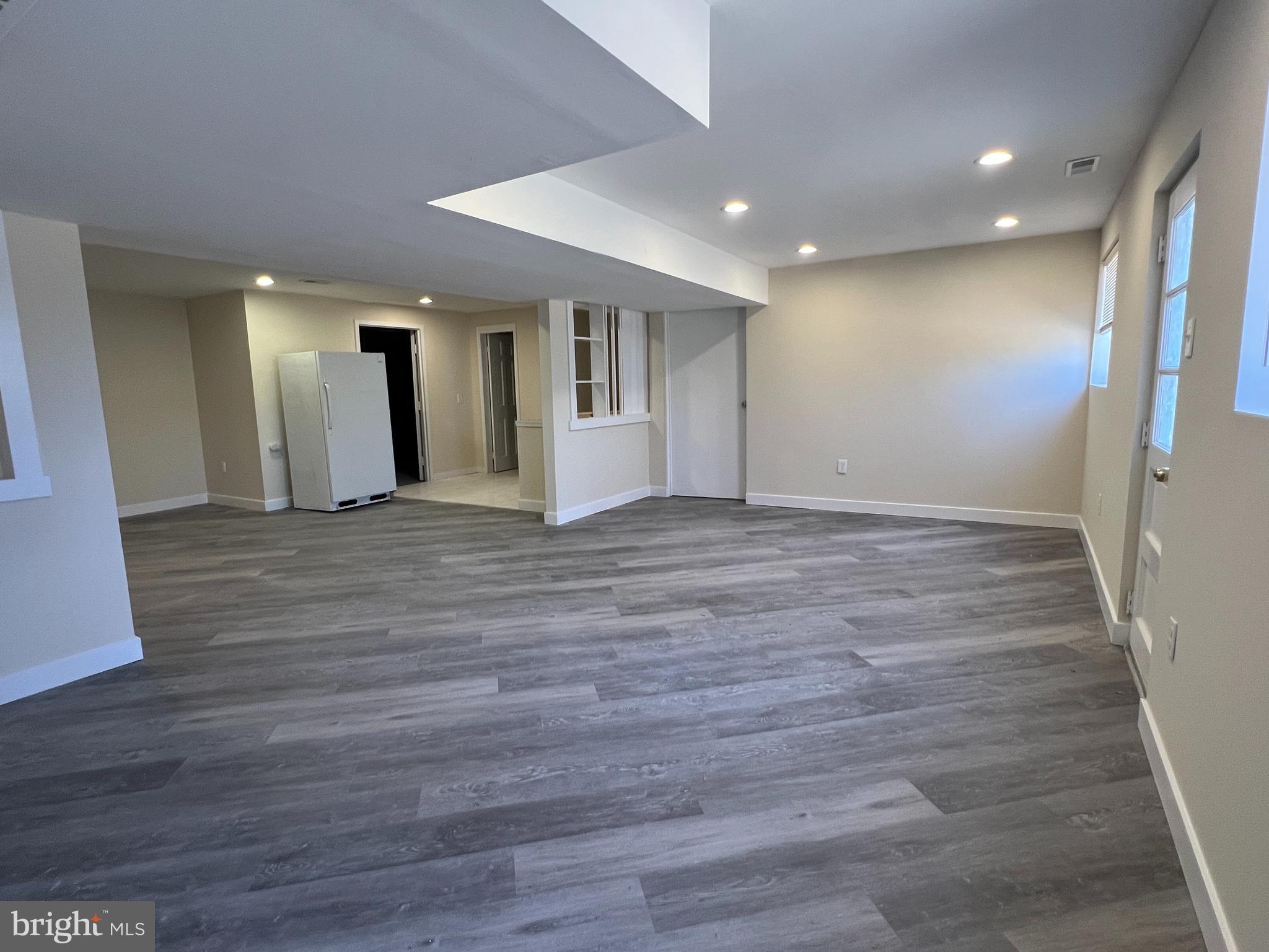 7510 Sanner Road Laurel, MD 20723 - Photo 15 of 26 a view of an empty room with wooden floor and a window