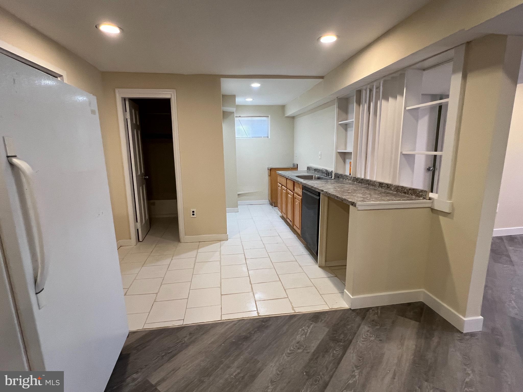 7510 Sanner Road Laurel, MD 20723 - Photo 18 of 26 a kitchen with stainless steel appliances a refrigerator and wooden floor