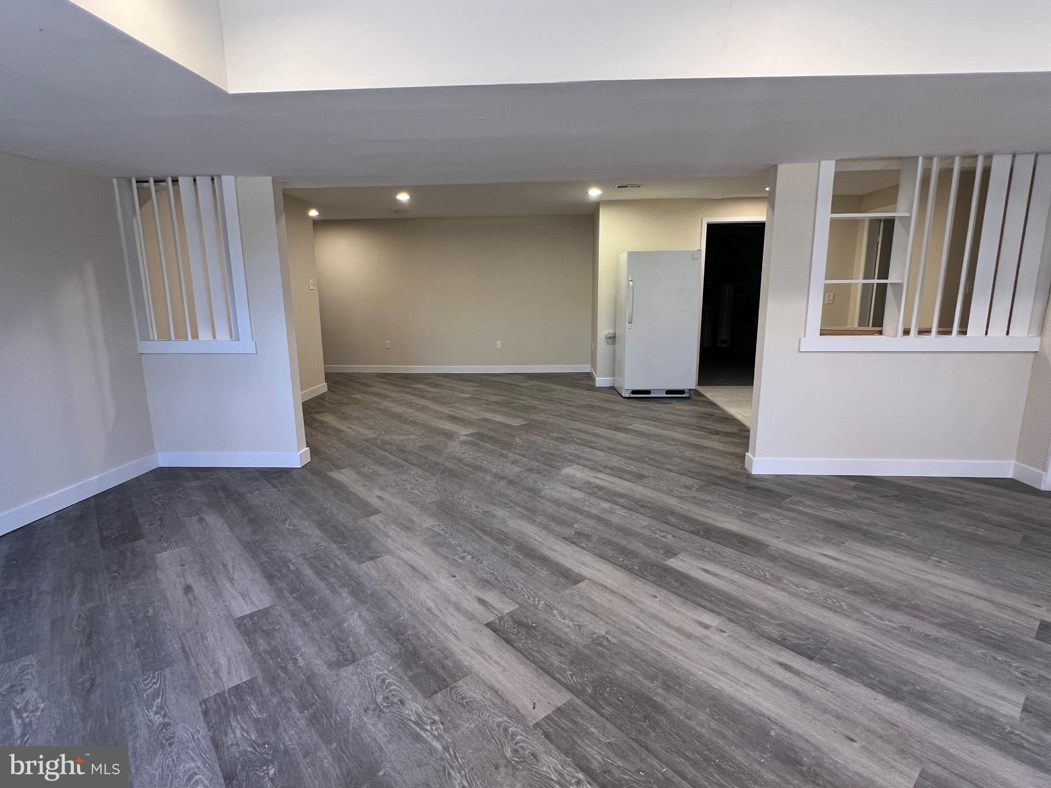 7510 Sanner Road Laurel, MD 20723 - Photo 21 of 26 a view of empty room with wooden floor and entryway