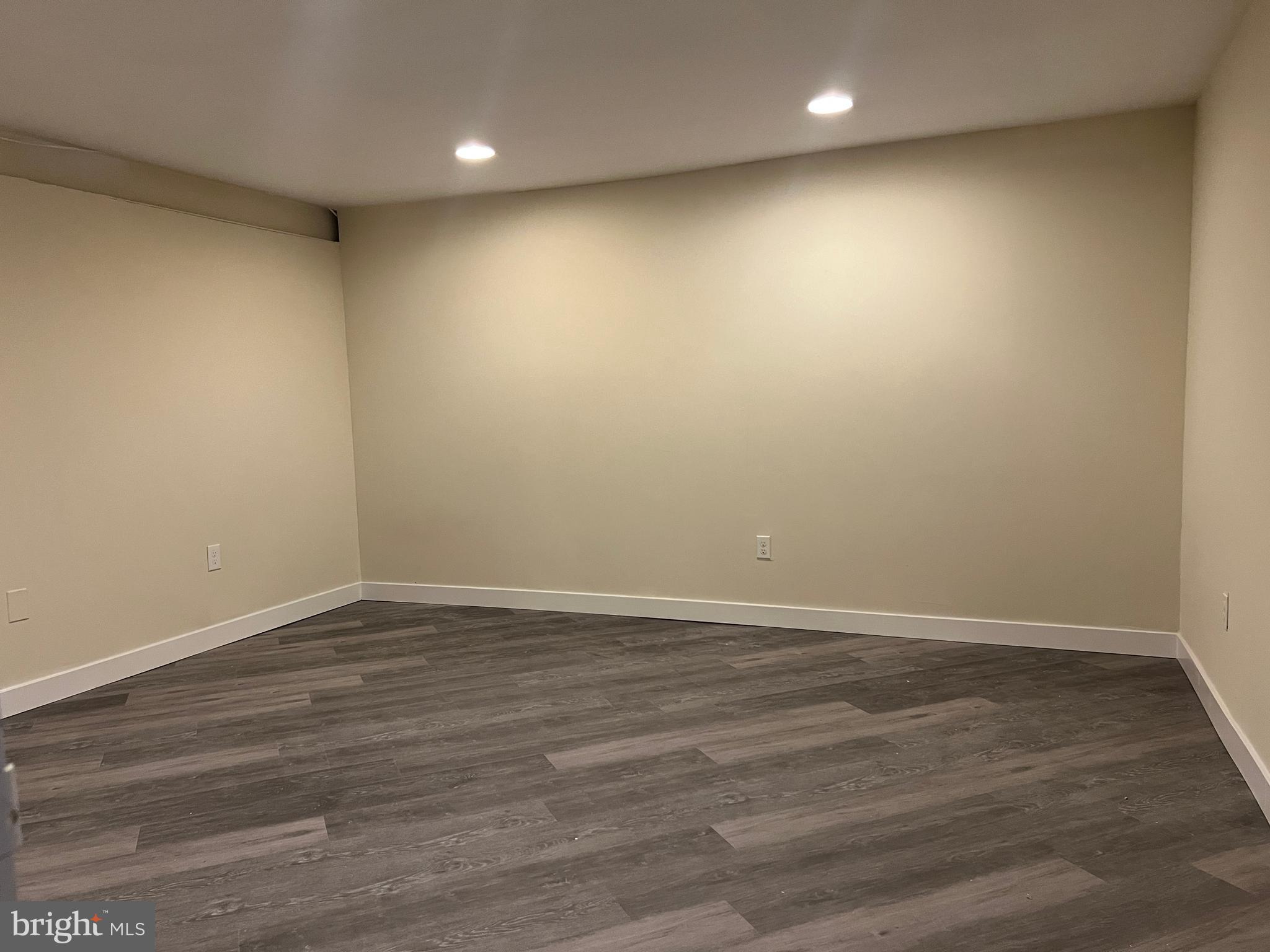 7510 Sanner Road Laurel, MD 20723 - Photo 23 of 26 an empty room with wooden floor and natural light