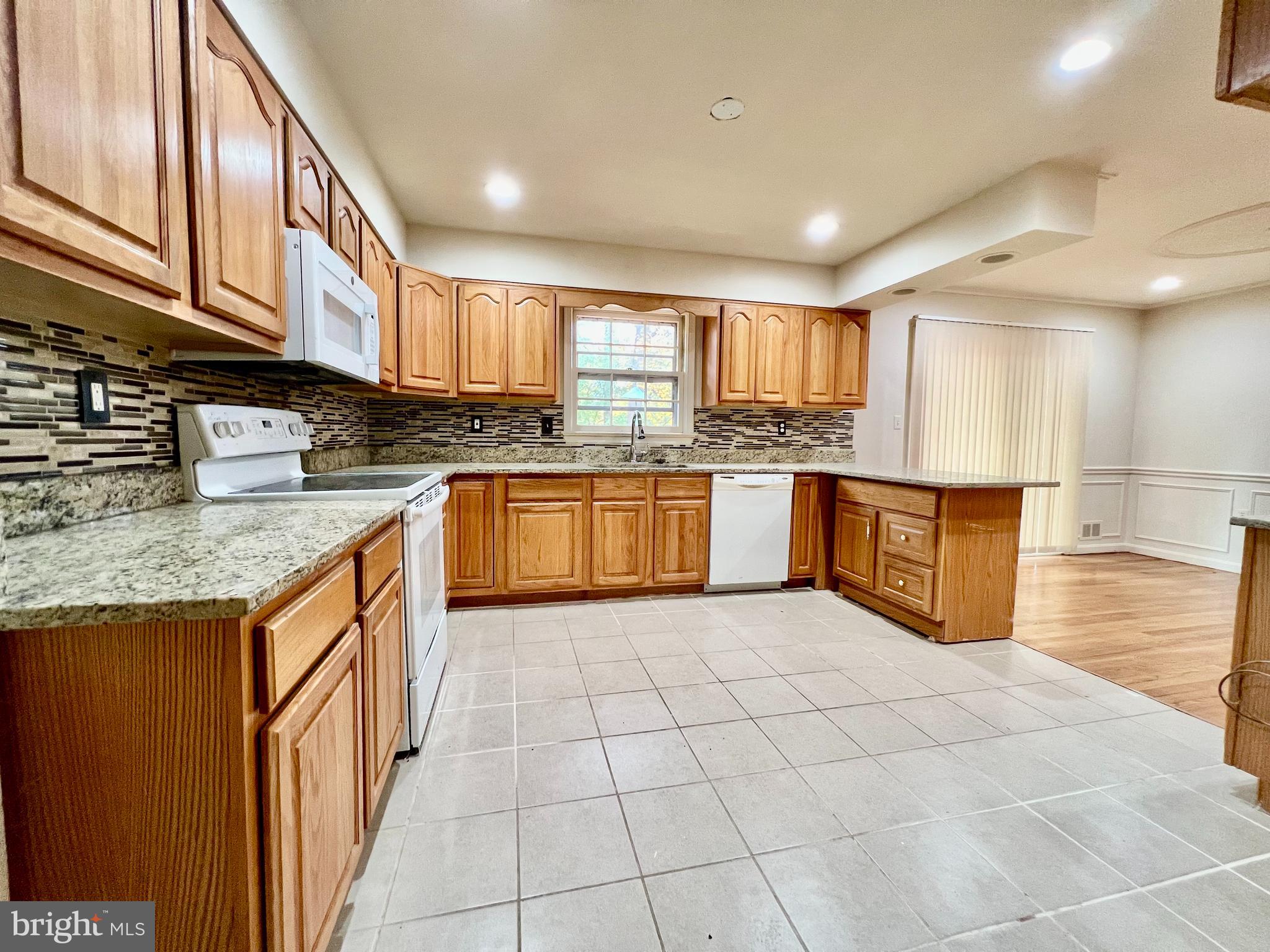 7510 Sanner Road Laurel, MD 20723 - Photo 3 of 26 a kitchen with stainless steel appliances granite countertop a sink and cabinets