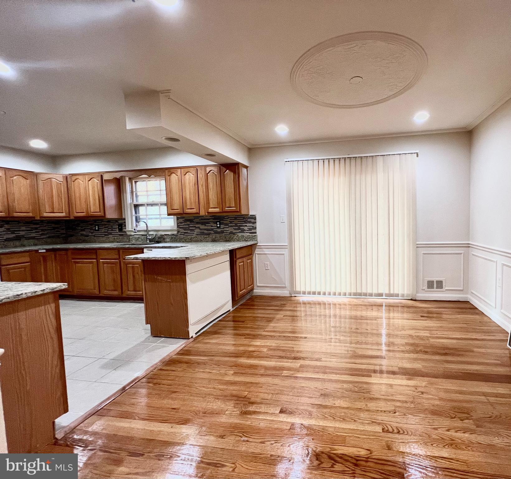 7510 Sanner Road Laurel, MD 20723 - Photo 5 of 26 a kitchen with stainless steel appliances granite countertop a stove a sink and a microwave
