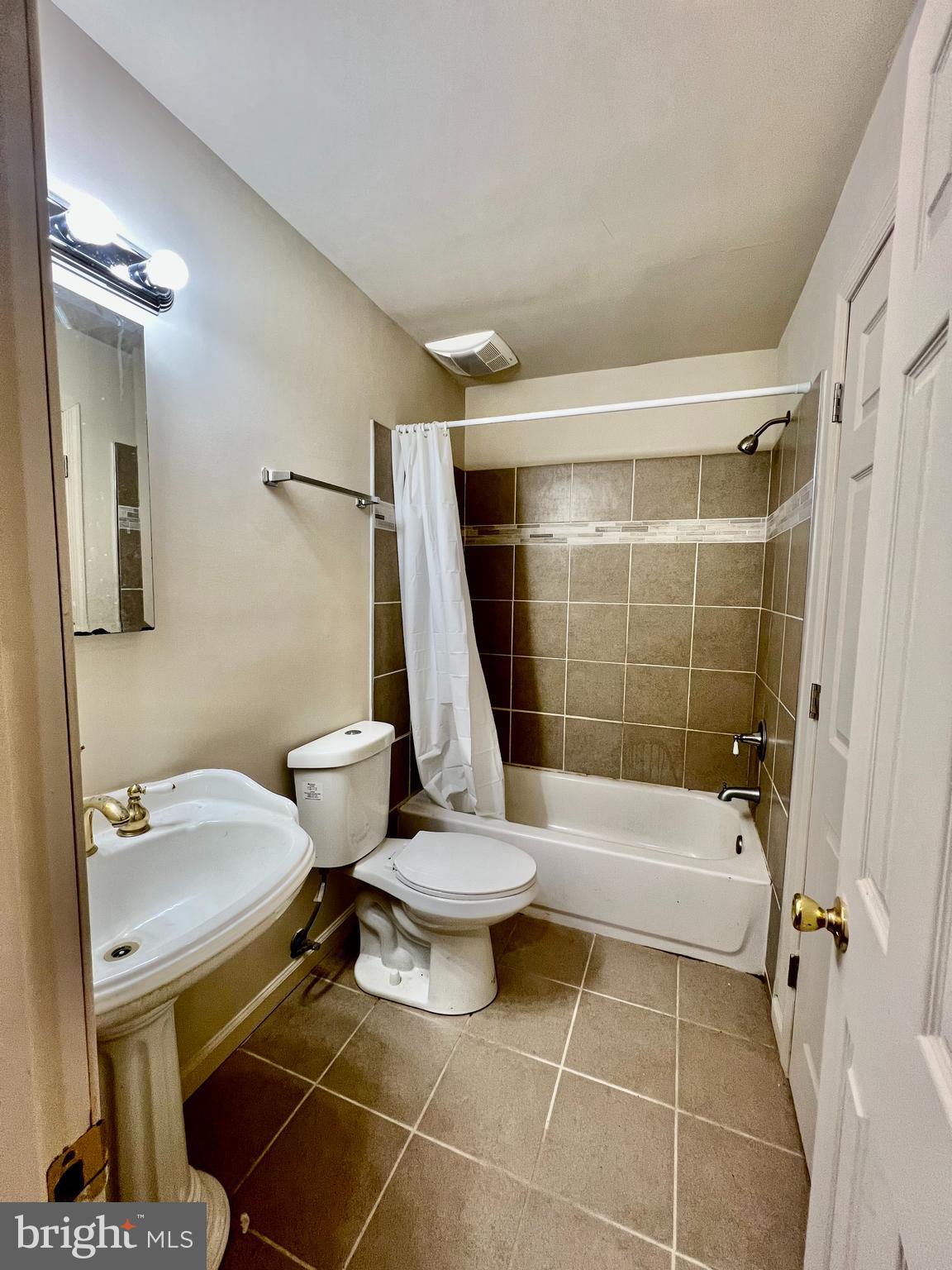 7510 Sanner Road Laurel, MD 20723 - Photo 10 of 26 a bathroom with a sink toilet and shower