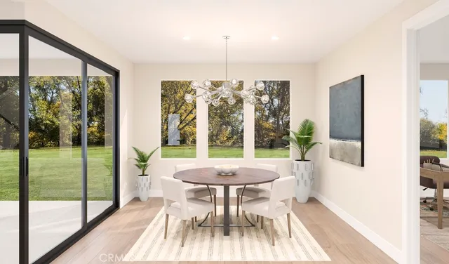 a view of a dining room with furniture wooden floor and a chandelier