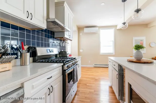 a kitchen with stainless steel appliances a sink dishwasher stove and refrigerator