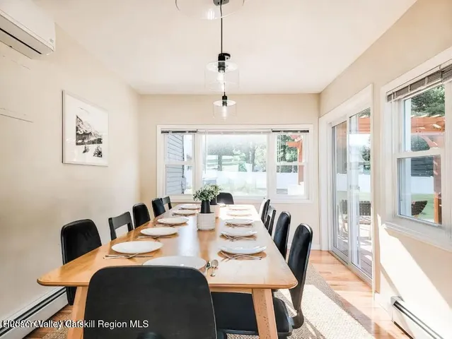 a view of a dining room with furniture a chandelier and wooden floor