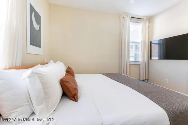 a living room with a flat screen tv and furniture