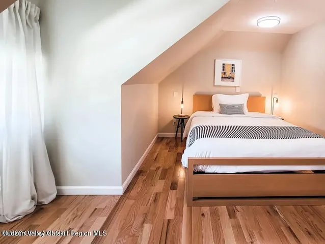 a living room with a bed furniture and a window