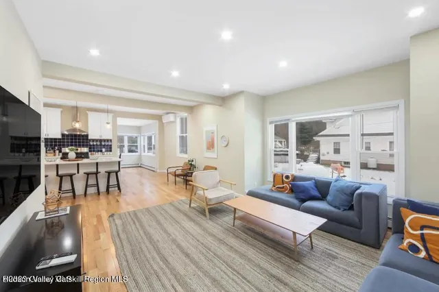 a living room with furniture and a wooden floor