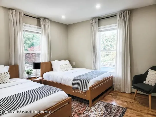 a large bedroom with a bed and a window
